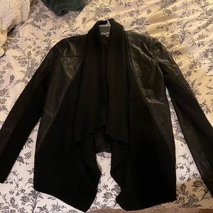 Black leather jacket with soft fabrics detailing around arms and front